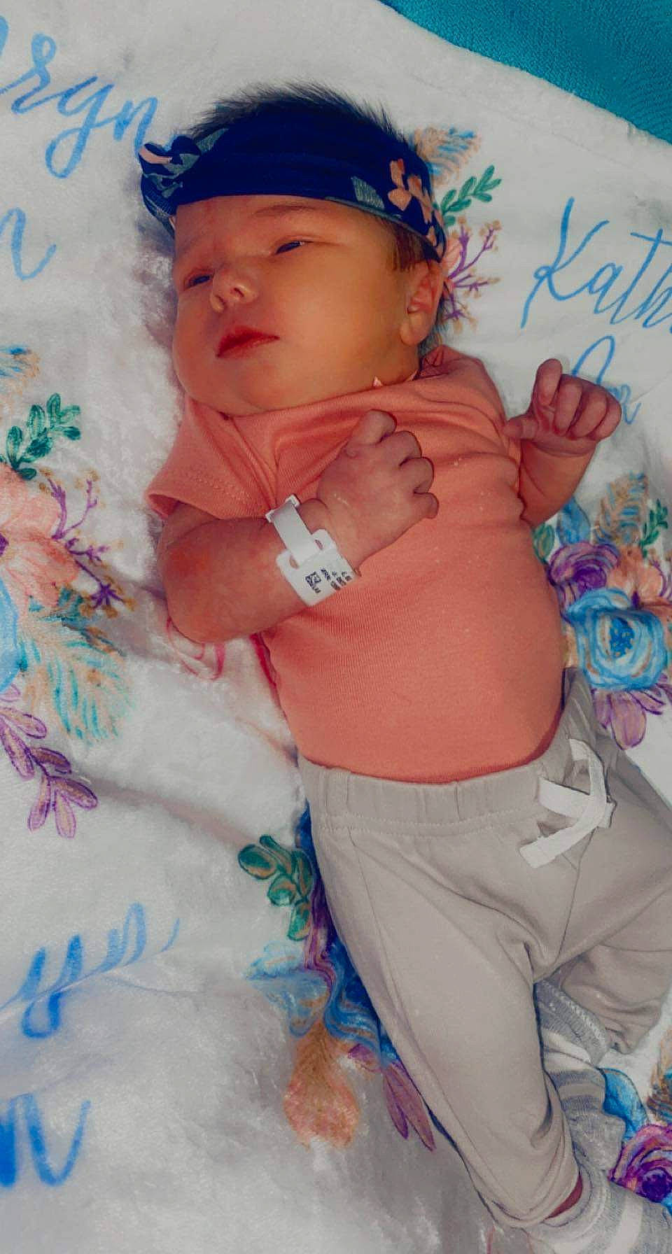 Kathryn is registered to the contest to win money with this photo: abdomen, azure, baby, baby_toddler_clothing, baseball_cap, blue, cap, chest, eye, happy, hat, headwear, human_body, pattern, person, pink, skin, t_shirt, textile, thigh