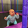 baby, child, indoor, playground, trampoline, purple, blue, crawling, smiling, happy, padded_pole, netting, clothing, socks, floor, curious, young_child, expression, play, fun