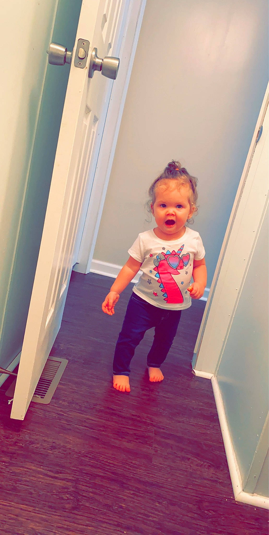 Ireland is registered to the contest to win money with this photo: baby, child, door, floor, flooring, fun, leg, person, pink, play, product, shoe, skin, smile, standing, surprise, toddler, vacation