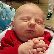 Zedadiah. joined the competition — help win amazing prizes! baby, sleeping, infant, blanket, hands, face, indoor, clothing, red_sweater, furniture, chair, table, floor, person, child, peaceful, cozy, home, portrait, newborn
