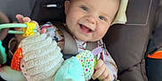Mckinleigh is registered to the contest to win money with this photo: baby, car_seat, smiling, toy, plush, blanket, child, infant, happy, seatbelt, person, indoors, clothing, colorful, cute, face, head, comfort, baby_toy, car