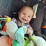 baby, car_seat, smiling, toy, plush, blanket, child, infant, happy, seatbelt, person, indoors, clothing, colorful, cute, face, head, comfort, baby_toy, car