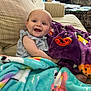 Mckinleigh is registered to the contest to win money with this photo: baby, smile, blanket, couch, child, happy, indoor, cozy, comfort, toddler, colorful, plush, clothing, furniture, portrait, infant, cute, relaxing, homedecor, person