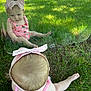 Mckinleigh is registered to the contest to win money with this photo: baby, child, reflection, mirror, grass, outdoor, headband, pink, strawberry_print, summer, sunlight, curious, sitting, nature, young_child, grass_field, play, casual_clothing, daylight, portrait
