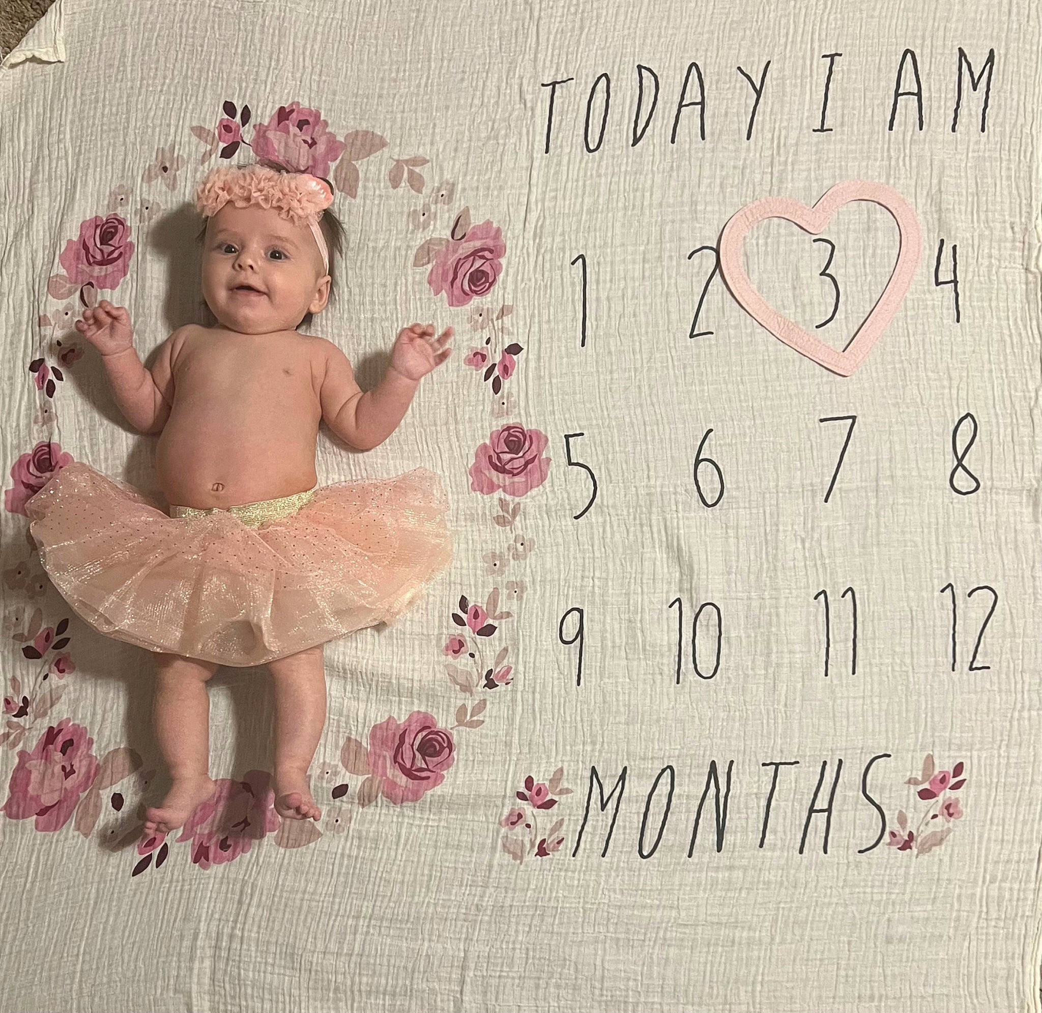 Lydia is registered to the contest to win money with this photo: art, baby, baby_toddler_clothing, child, font, foot, greeting_card, happy, headwear, linens, magenta, paper, paper_product, pattern, person, petal, photo_caption, pink, rectangle, smile
