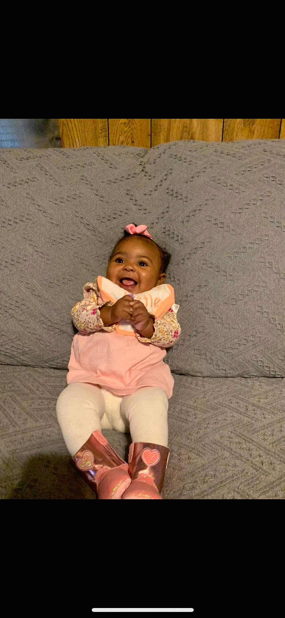 Asiah is registered to the contest to win money with this photo: baby, baby_laughing, baby_toddler_clothing, boot, child, child_model, comfort, foot, hair_accessory, headband, headwear, human_body, linens, person, photo_shoot, pink, sand, sitting, sock, toddler