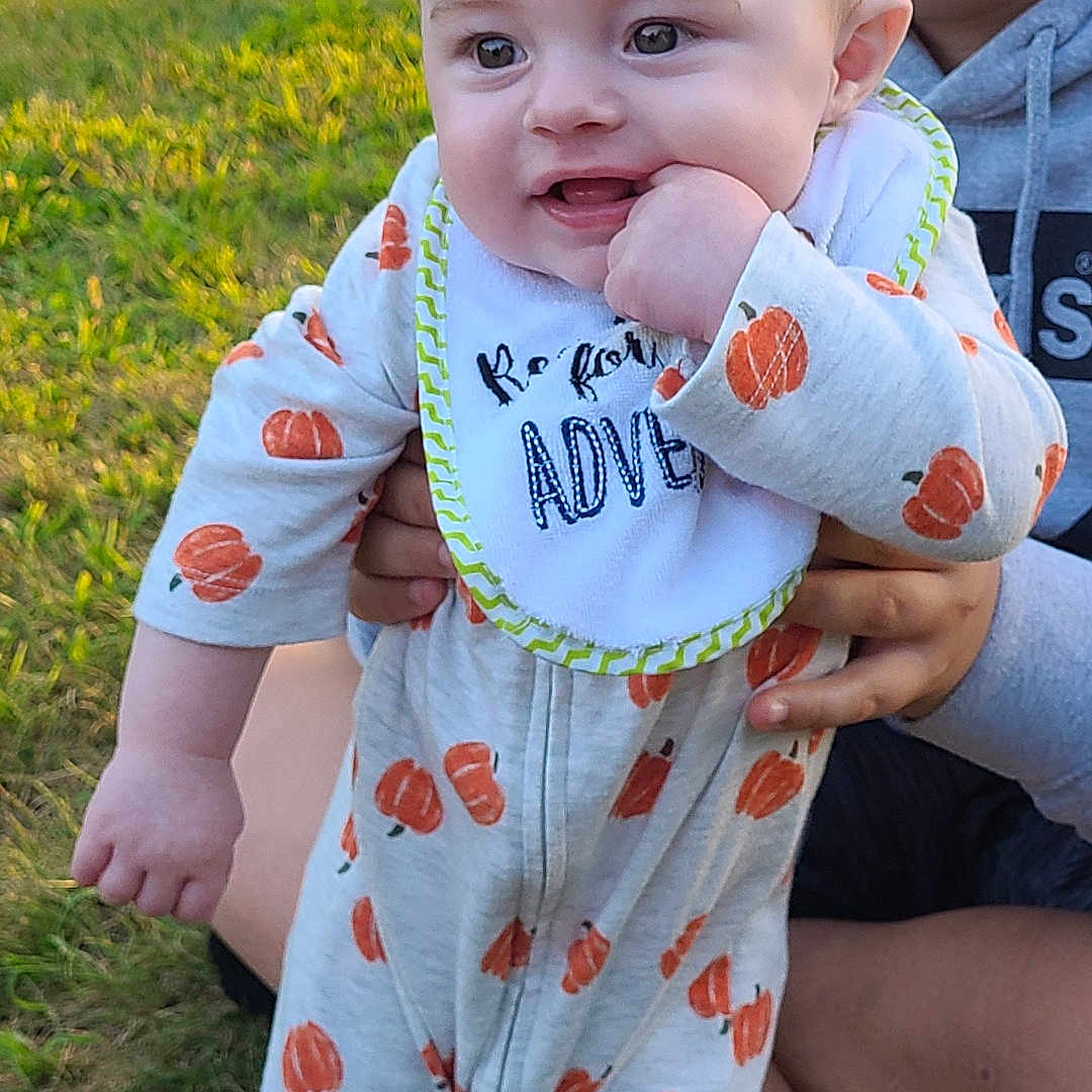 Rory joined the competition — help win amazing prizes! baby, clothing, dress, face, footwear, grass, happy, head, lawn, nature, outdoors, pajamas, pants, park, person, photography, plant, portrait, shoe, yard