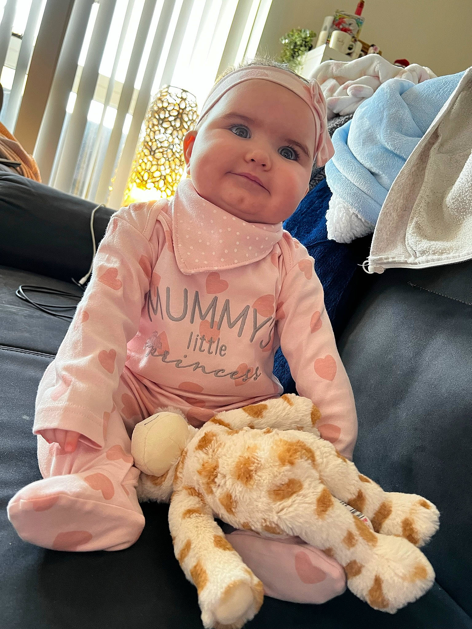 Delilah joined the competition — help win amazing prizes! baby, baby_products, baby_safety, baby_sleeping, baby_toddler_clothing, child, comfort, curtain, fun, fur, happy, headwear, houseplant, linens, person, sitting, smile, stuffed_toy, teddy_bear, textile