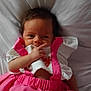 Constance a rejoint le concours — aidez-le/la à gagner de superbes lots ! baby, infant, child, pink_skirt, white_top, bed, bedding, lying_down, hand, face, curious, clothing, cute, person, newborn, skin, hair, indoors, soft_light, portrait