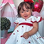 Amanda joined the competition — help win amazing prizes! toddler, child, smiling, dress, strawberry_pattern, headband, flower_accessory, play_tent, balloon, indoor, tablecloth, checkered, plant, pot, cute, sitting, happy, portrait, person, decor