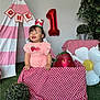 Amanda joined the competition — help win amazing prizes! baby, child, birthday, first_birthday, crown, balloon, strawberry, pink, red, checkered, tablecloth, tent, plant, greenery, grass, smiling, happy, indoors, decorations, celebration