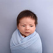 Santiago is registered to the contest to win money with this photo: baby, blanket, blue, child, closeup, curious, cute, expression, face, hair, head, indoors, infant, newborn, portrait, skin, soft, swaddled, wrapped, young