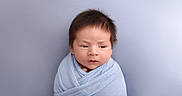 Santiago is registered to the contest to win money with this photo: baby, blanket, blue, child, closeup, curious, cute, expression, face, hair, head, indoors, infant, newborn, portrait, skin, soft, swaddled, wrapped, young