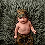 Santiago joined the competition — help win amazing prizes! baby, camouflage, child, cute, expression, fluffy_rug, green, hat, indoors, infant, lying_down, military_style, pants, person, portrait, shirtless, small_hand, soft, texture, young_child