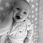 Arlo-Lee is registered to the contest to win money with this photo: baby, infant, smile, hand, blanket, stars, teddy_bear, clothing, cute, happy, face, portrait, child, lying_down, cozy, soft, newborn, person, monochrome, black_and_white