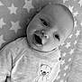 Arlo-Lee is registered to the contest to win money with this photo: baby, smile, face, infant, sweater, teddy_bear, blanket, stars, pattern, cute, child, portrait, young, lying_down, comfort, happy, clothing, soft, monochrome, closeup