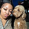 woman, dog, indoor, portrait, curly_hair, brown_dog, affection, closeup, face, pet, cute, love, expression, casual_clothing, home, animal, friendship, leisure, pout, furry