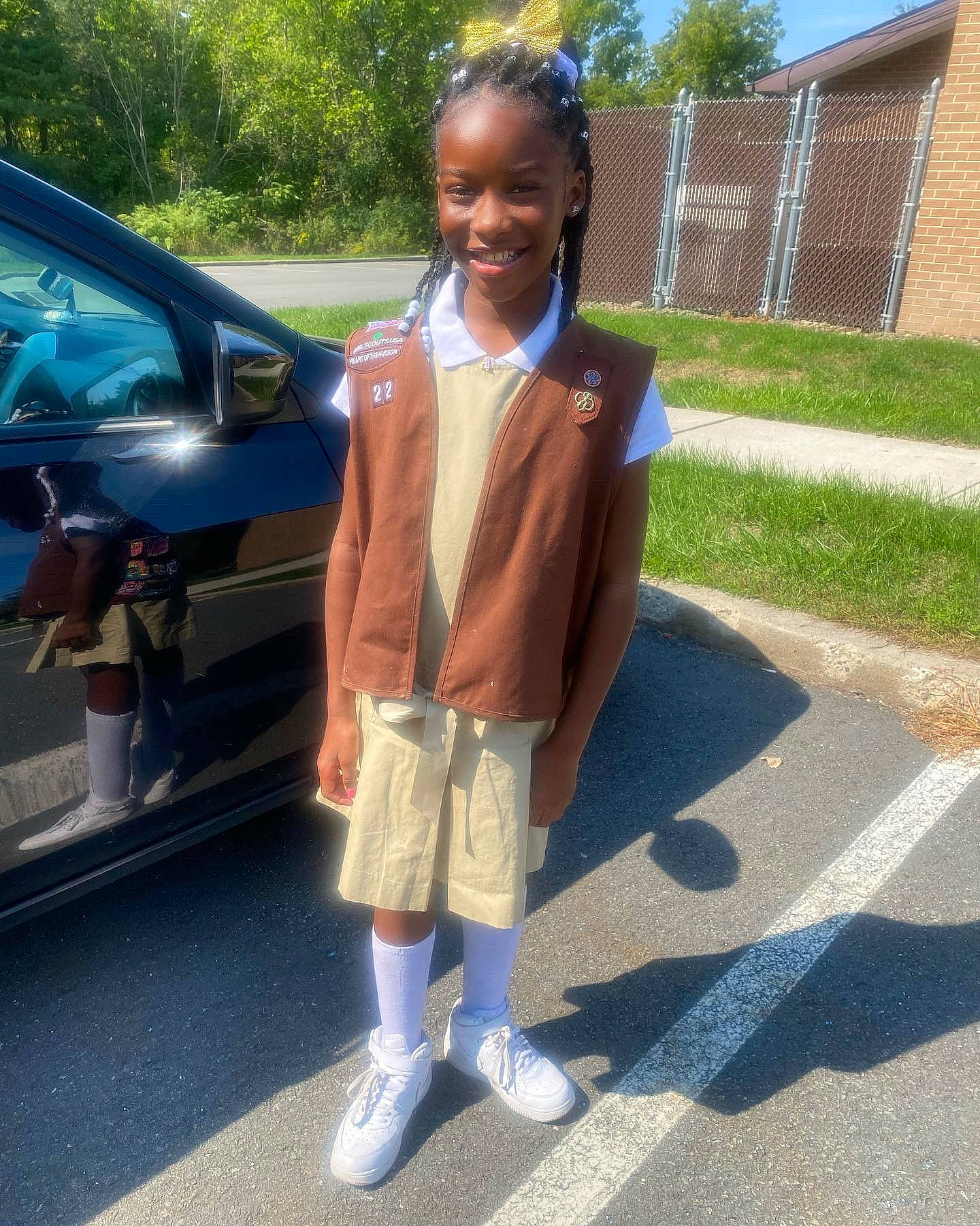 Azariah is registered to the contest to win money with this photo: asphalt, automotive_exterior, automotive_lighting, car, electric_blue, family_car, fun, joy, leisure, luxury_vehicle, motor_vehicle, person, school_uniform, shorts, smile, tie, toddler, tree, trunk, uniform