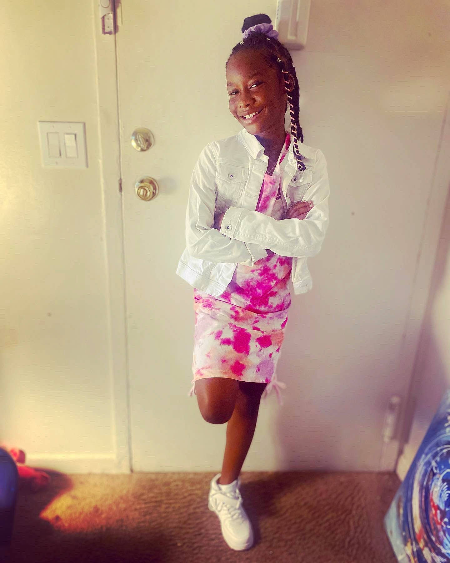 Azariah is registered to the contest to win money with this photo: child, cool, door, electric_blue, face, fashion_design, flooring, fun, happy, human_leg, joy, knee, leg, magenta, pattern, person, pink, purple, room, sleeve