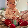 baby, bed, blanket, child, christmas, cup, cute, face, hands, hat, holiday, indoors, infant, pajamas, portrait, red, sitting, sock, toy, white