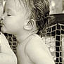 affection, arm, baby, child, close_up, curly_hair, cute, emotion, innocence, kiss, netting, outdoor, portrait, profile, sepia, skin, soft_light, tender_moment, toddler, young_child