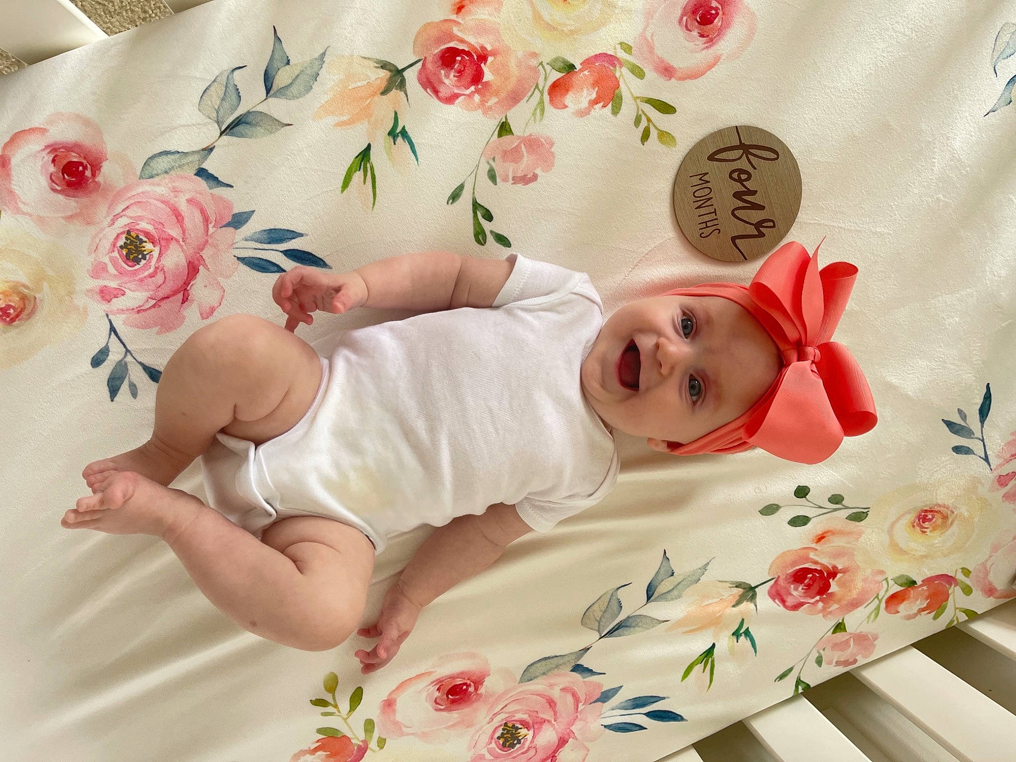 Ava is registered to the contest to win money with this photo: arm, baby, baby_toddler_clothing, child, comfort, dress, finger, flower, hand, hat, headwear, leg, person, petal, pink, plant, product, skin, sleeve, smile