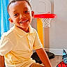King joined the competition — help win amazing prizes! basketball_hoop, boy, casual_clothing, child, curtain, floor, furniture, happy, home, indoor, playroom, portrait, smiling, superhero_wall_decals, tan_pants, toy, wall, window, yellow_shirt, young_child