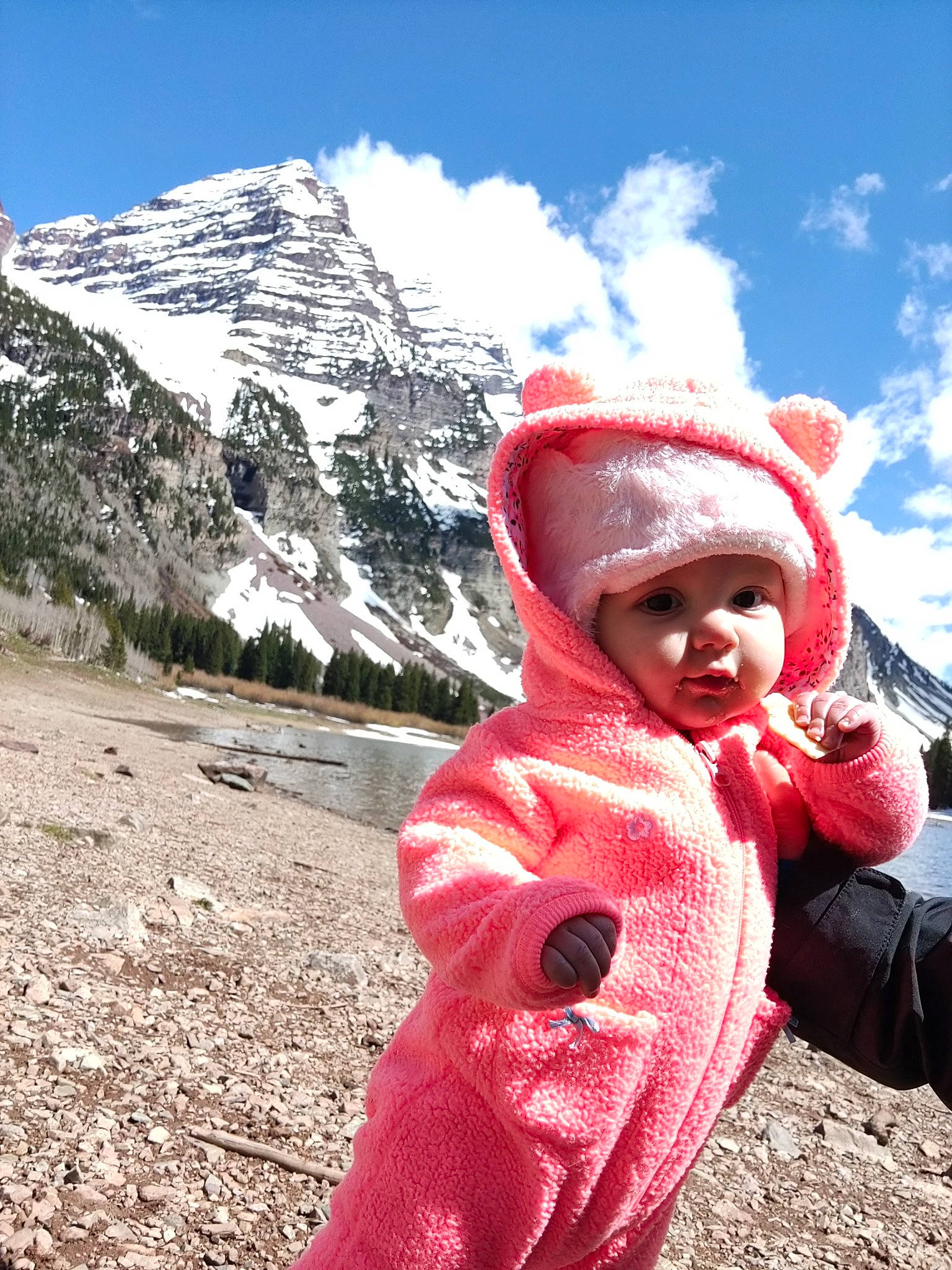 Zoey is registered to the contest to win money with this photo: cap, cloud, freezing, happy, headgear, headwear, ice_cap, jacket, landscape, leisure, mountain, mountain_range, outerwear, people_in_nature, person, recreation, sky, smile, snow, toddler