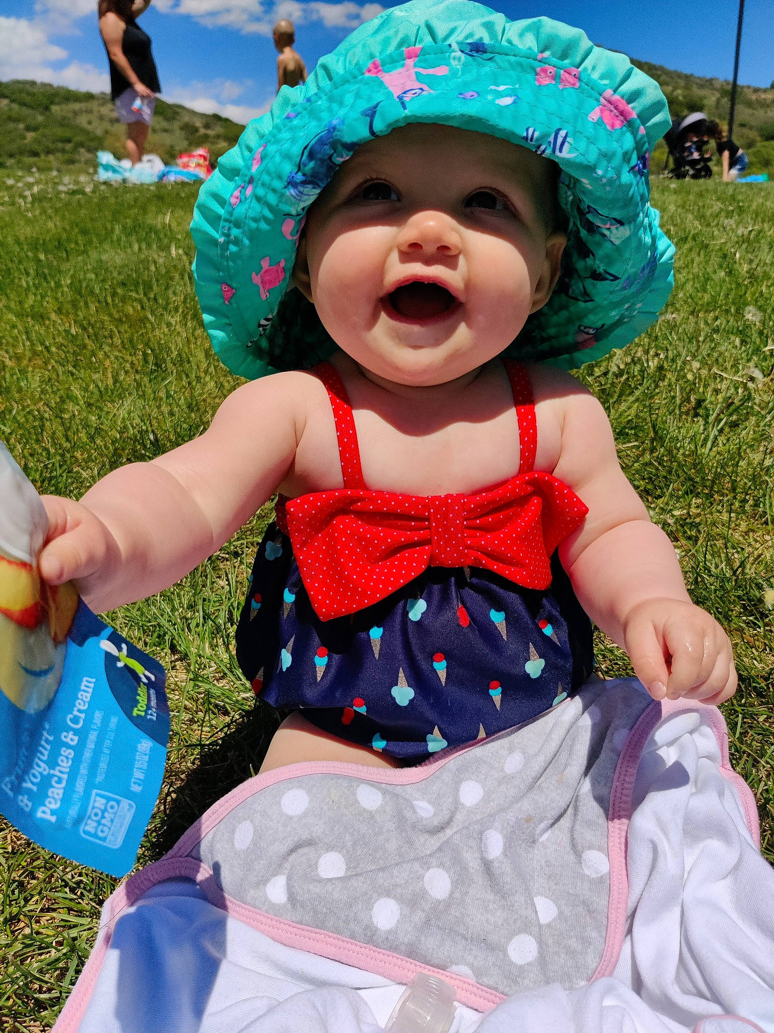 Zoey is registered to the contest to win money with this photo: azure, baby_toddler_clothing, blue, cap, child, fun, grass, green, happy, hat, headwear, leisure, pattern, person, photograph, pink, plant, sky, smile, summer