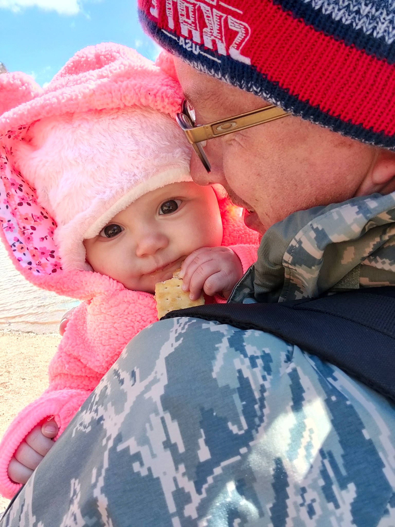 Zoey is registered to the contest to win money with this photo: baby, baseball_cap, cap, child, eye, face, fun, gesture, happy, headgear, headwear, knit_cap, lip, marines, military_camouflage, military_person, military_uniform, outerwear, person, pink