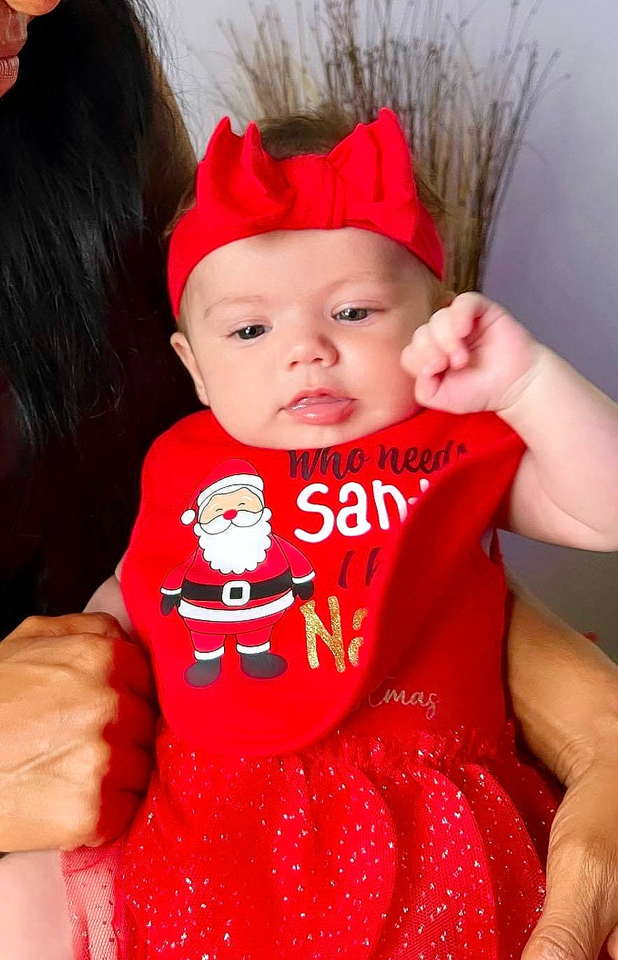 Jaylyn is registered to the contest to win money with this photo: baby, baby_toddler_clothing, carmine, child, christmas, costume_accessory, costume_hat, event, fashion_accessory, fictional_character, fun, happy, headwear, holiday, lip, pattern, person, pink, red, sleeve