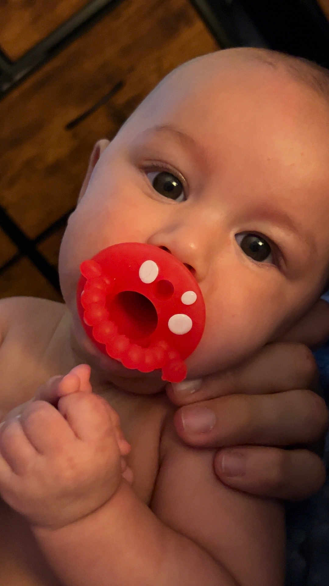 Autumn is registered to the contest to win money with this photo: baby, child, close_up, cute, expression, eyes, face, fingers, hand, holding, human, indoor, infant, mouth, newborn, pacifier, person, portrait, skin, soft_light