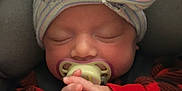 Autumn is registered to the contest to win money with this photo: baby, sleeping, pacifier, hat, bow, blanket, hands, infant, cute, child, cozy, colorful, striped, newborn, closeup, soft, warm, rest, carseat, portrait
