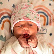 Autumn joined the competition — help win amazing prizes! baby, newborn, infant, hat, clenched_fists, blanket, stars, rainbow, cute, sleepwear, face, portrait, child, soft_light, indoors, lying_down, patterned_clothing, peaceful, young, cozy