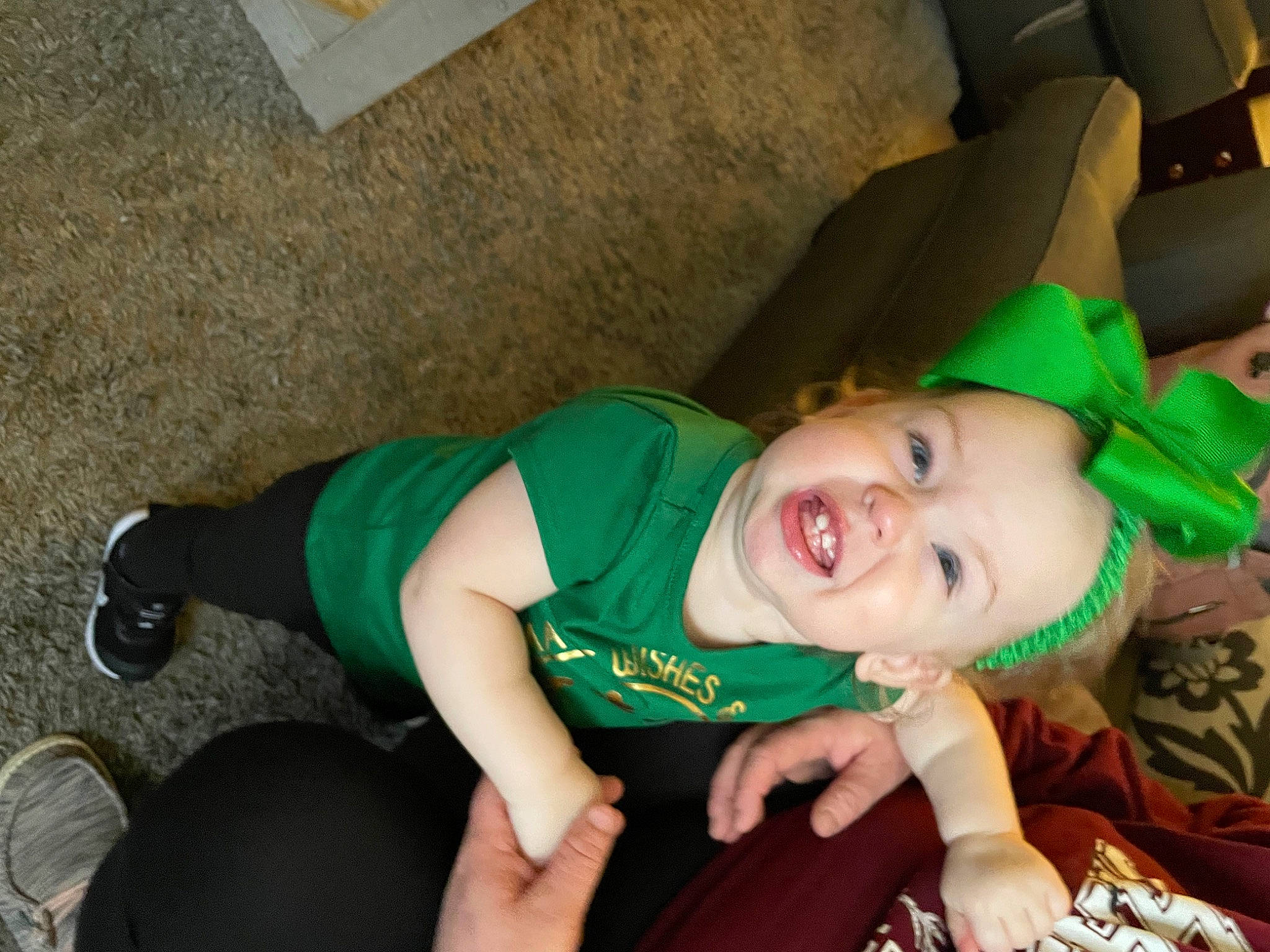 Emery is registered to the contest to win money with this photo: baby, baby_products, baby_toddler_clothing, child, costume, event, fashion_accessory, fun, grass, green, happy, hat, knee, lap, leg, person, sitting, smile, sock, thigh