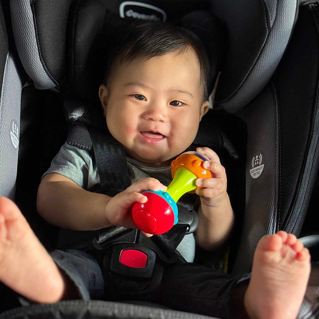 Kyle is registered to the contest to win money with this photo: baby, bodypart, car, car_interior, carseat, cushion, face, finger, gun, hand, happy, head, homedecor, person, photography, portrait, smile, transportation, vehicle, weapon