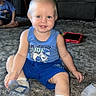 toddler, child, blue_shirt, socks, carpet, tablet, toy_dinosaur, indoor, living_room, furniture, adult, smiling, person, shorts, floor, playtime, happy, home, seated, casual