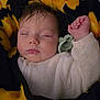 baby, sleeping, blanket, pacifier, infant, cozy, face, child, closed_eyes, hand, soft, cute, warm, portrait, peaceful, resting, clothing, young_child, indoors, comfort