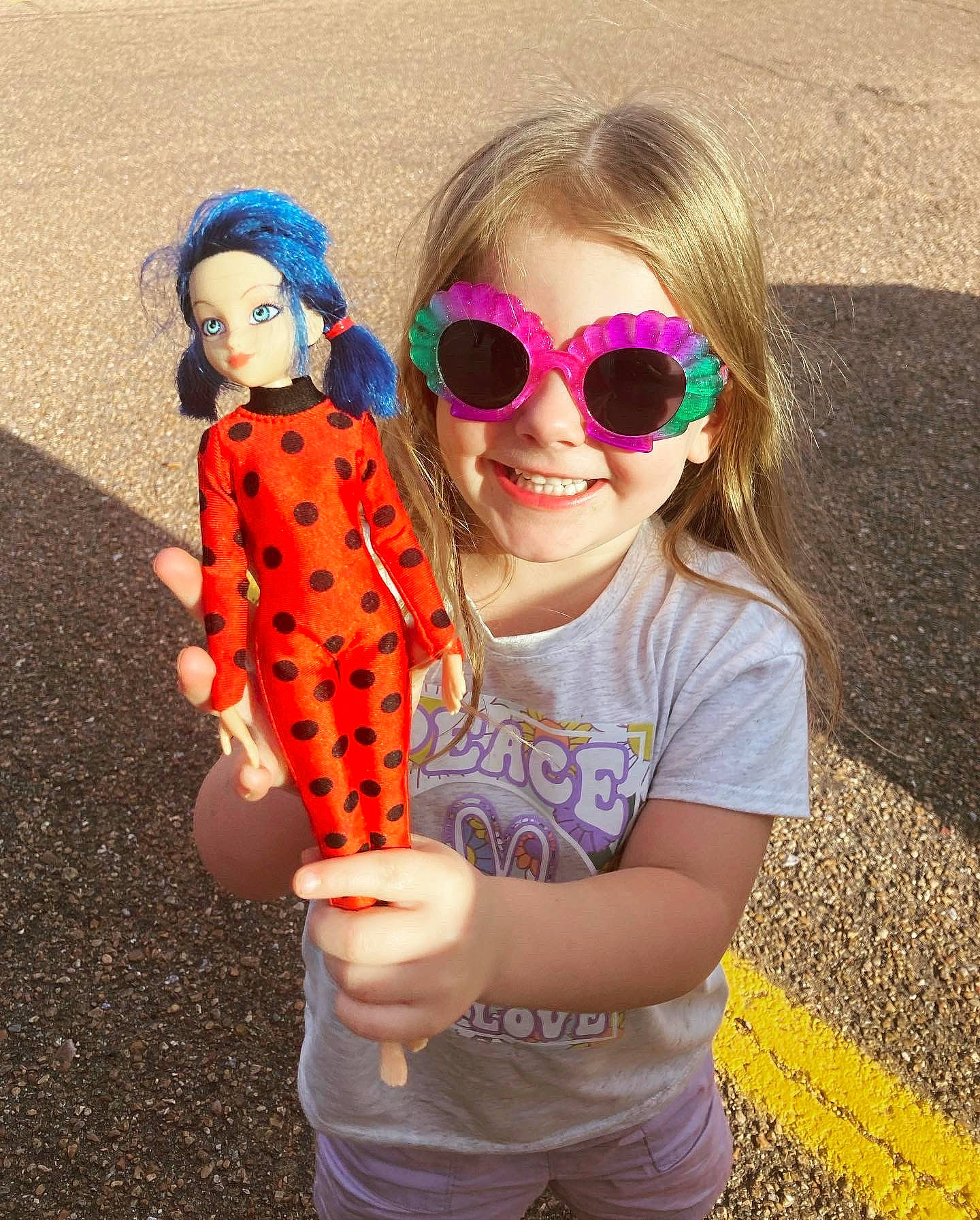 Kimberly joined the competition — help win amazing prizes! child, cool, doll, eyewear, facial_expression, finger, fun, gesture, glasses, goggles, hand, happy, joy, pattern, person, pink, sleeve, smile, sunglasses, toy