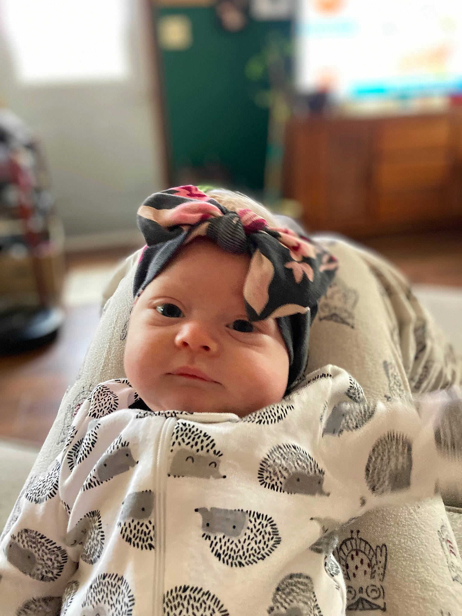 Lila is registered to the contest to win money with this photo: baby, cap, child, comfort, eye, eyelash, face, facial_expression, fun, fur, happy, hat, head, linens, pattern, person, portrait_photography, room, sitting, skin
