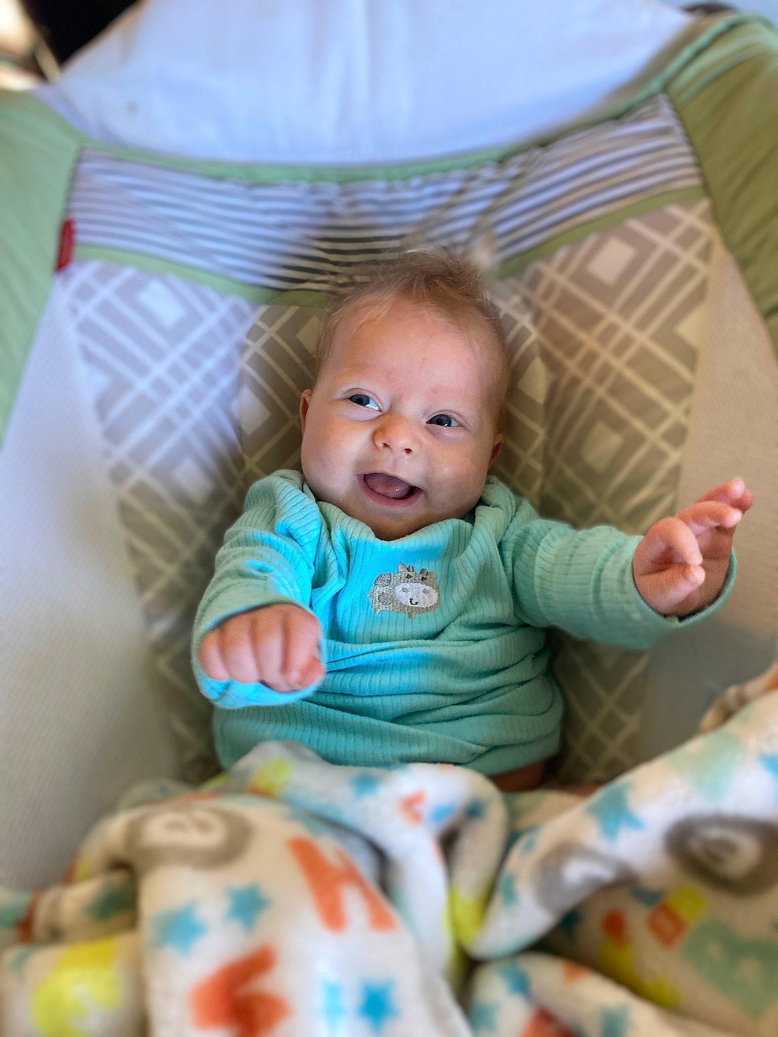 Lila is registered to the contest to win money with this photo: baby, baby_products, baby_toddler_clothing, cheek, child, comfort, eye, face, fun, happy, head, iris, linens, person, sitting, skin, sleeve, smile, textile, toddler