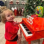 barefoot, carpet, child, christmas_tree, cute, festive, furniture, happy, holiday_decor, home, indoor, playing, red_piano, red_sweater, smiling, stockings, stool, toddler, toy_piano, young_child