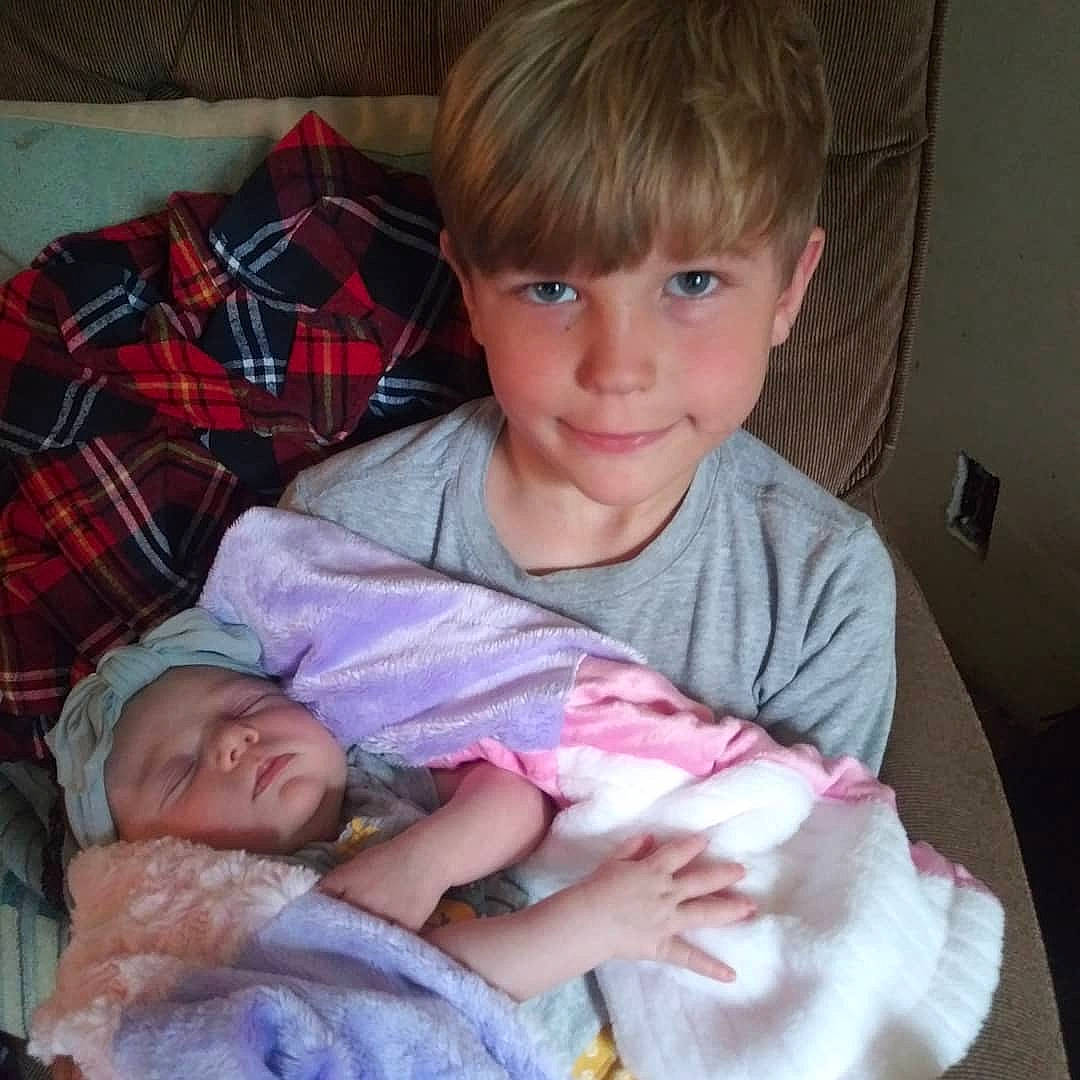 Ayven is registered to the contest to win money with this photo: baby, baby_toddler_clothing, cheek, child, comfort, couch, finger, iris, joy, lap, organ, person, pink, plaid, room, sharing, sitting, skin, smile, tartan