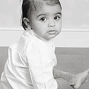 Ivaan joined the competition — help win amazing prizes! toddler, child, sitting, floor, white_shirt, pants, portrait, black_and_white, curious, wide_eyes, indoor, flooring, baby, young_child, looking_back, studio_photo, monochrome, short_hair, cute, innocent