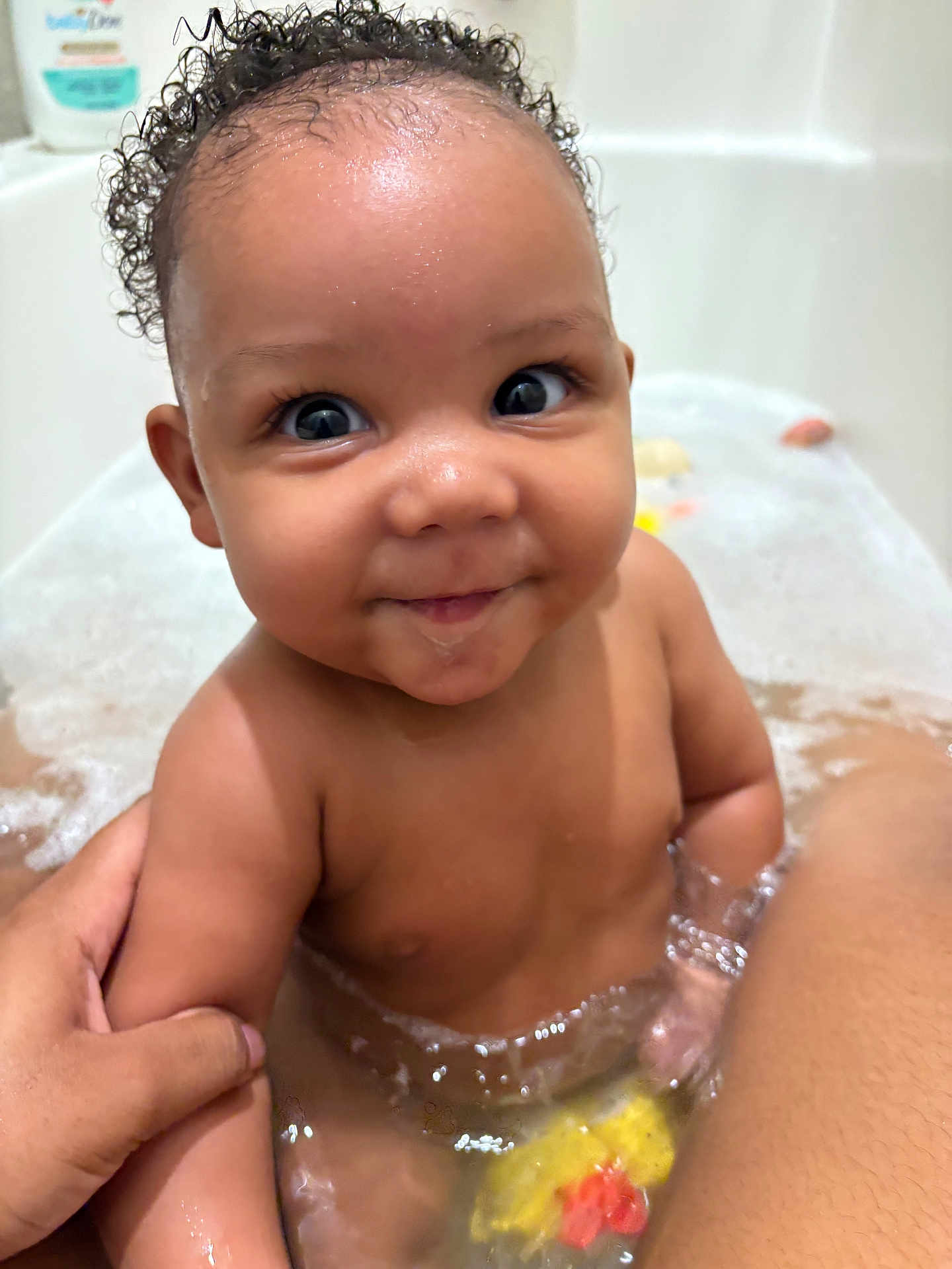 Tymir joined the competition — help win amazing prizes! baby, bath, bathtub, bubbles, child, curly_hair, cute, face, fun, happy, holding_hand, indoors, person, playful, rubber_ducky, smile, water, wet, young_child, skin