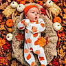 baby, infant, autumn, pumpkin, fall_leaves, orange, white_onesie, hat, blanket, hay_bale, pinecone, acorn, nature, outdoor, seasonal, cute, portrait, child, holiday, festive