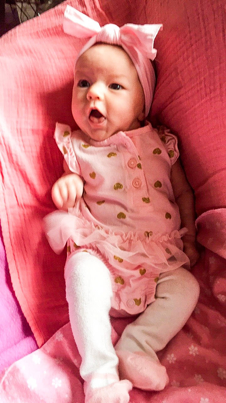 Flora is registered to the contest to win money with this photo: baby, cheek, child, headwear, person, pink, skin, smile, toddler