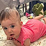 Cecilia is registered to the contest to win money with this photo: baby, infant, tummy_time, pink_onesie, polka_dots, toy, stuffed_animal, green_dinosaur, play_mat, floral_pattern, indoor, child, cute, curious, lying_down, face, wide_eyes, soft_lighting, home, colorful