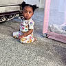 Aubree joined the competition — help win amazing prizes! toddler, child, indoor, carpet, pajamas, sitting, face, curly_hair, playpen, furniture, sofa, earrings, cute, expression, floor, room, colorful_clothing, person, home, portrait