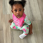Aubree joined the competition — help win amazing prizes! child, toddler, baby, pigtails, curly_hair, pink_bib, strawberry_print, onesie, socks, flooring, wood_floor, indoors, looking_up, cute, portrait, person, sitting, young_child, innocence, playful